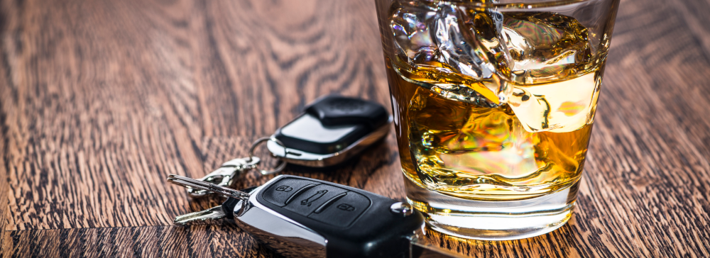 Car keys next to a glass of liquor symbolizing drunk driving accidents