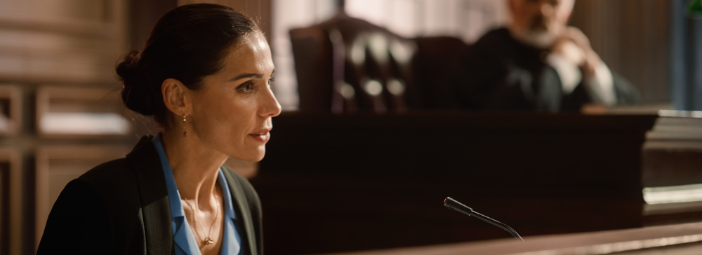 Woman testifying on the witness stand in a courtroom during a personal injury lawsuit