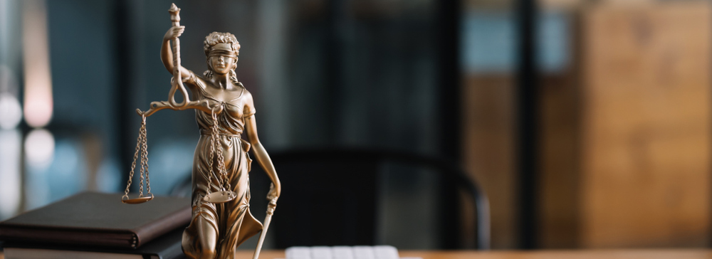Statue of lady justice on desk of a lawyer.