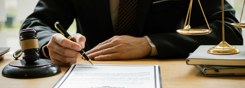Lawyer motioning to a legal document with a pen