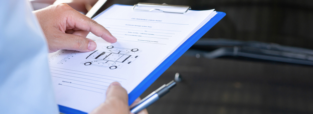 A person filling out an accident survey and gathering evidence at the scene of a car accident