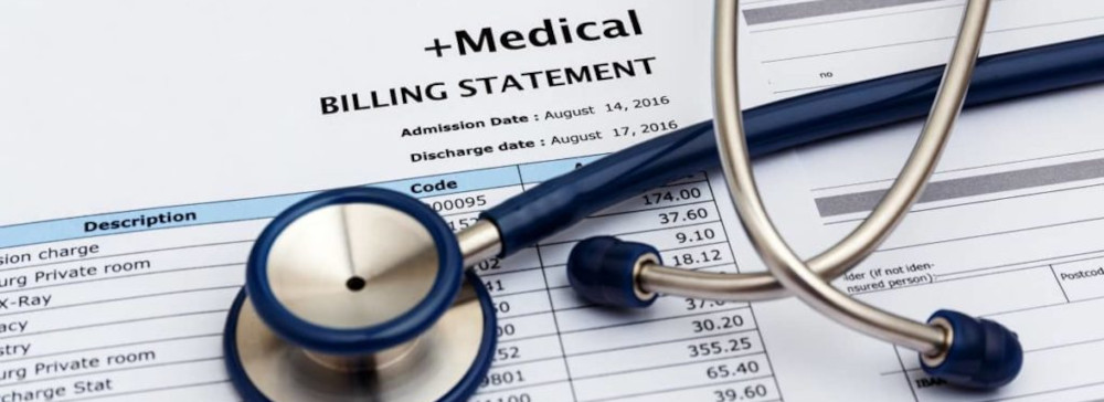 A medical billing statement with a stethoscope on top
