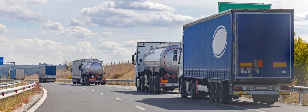 18-wheeler trucks lined up at a border crossing