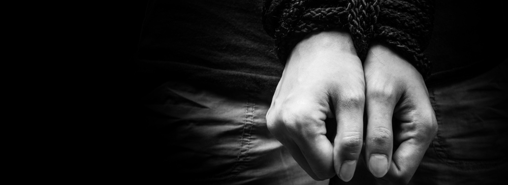 Tied up hands of a human trafficking victim