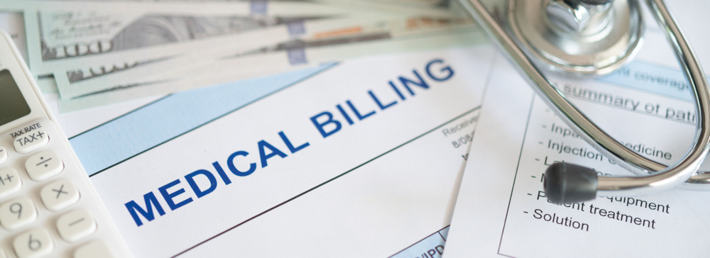 A medical bill after a personal injury accident with a stethoscope,  calculator, and hundred dollar bills. 