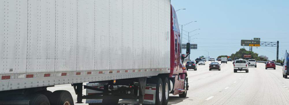 A semi-truck driving down the highway