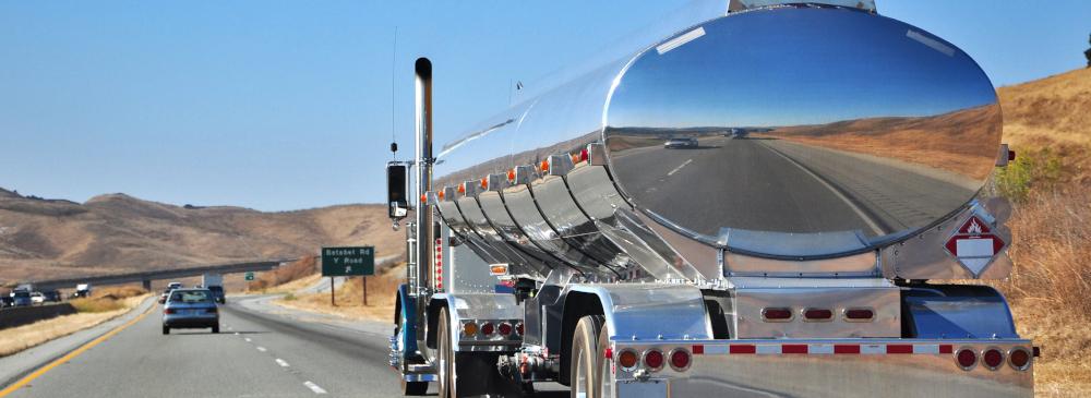 An oil tanker truck driving on a desert highway