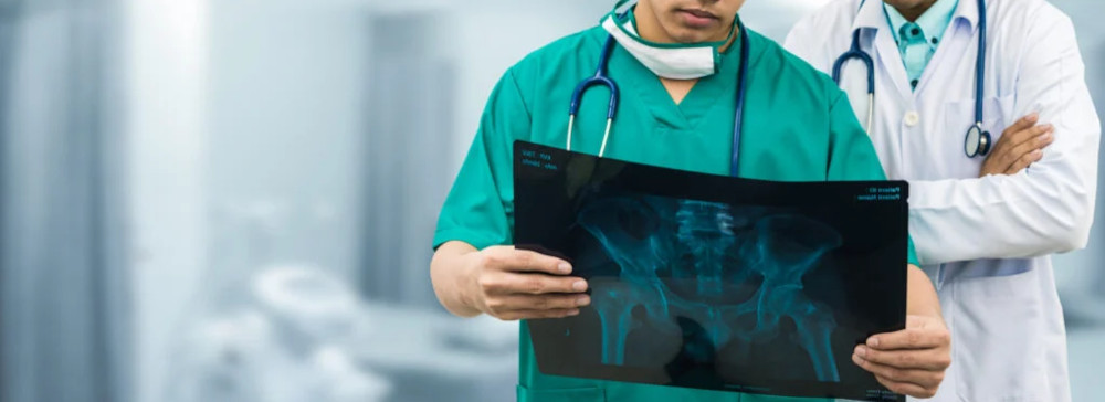 Doctors reviewing an Xray of a hip fracture injury