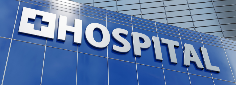 Exterior of a hospital building with a sign that says HOSPITAL