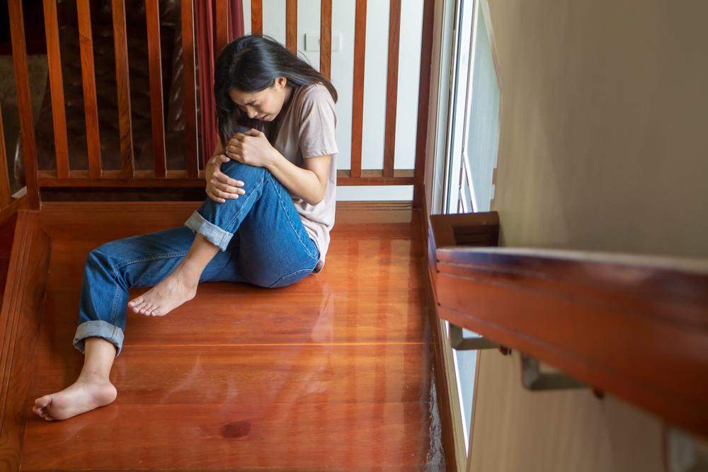 a woman holding her leg after falling