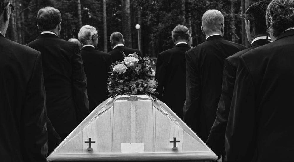 funeral procession carrying a coffin