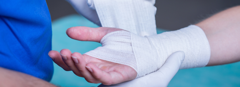 A doctor bandaging a patient's hand and wrist