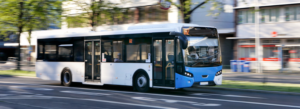 A public bus driving down a city street
