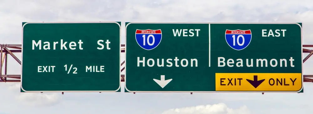 Interstate 10 signs showing Houston to the west and Beaumont to the east